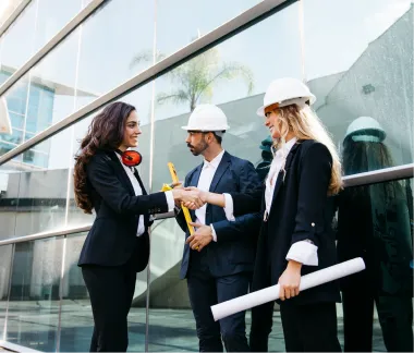 Builder and clients shaking hands over house plans